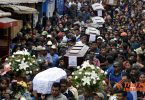Residents carry the coffins of 7 people who died following the eruption of the Fuego volcano in San Miguel Los Lotes