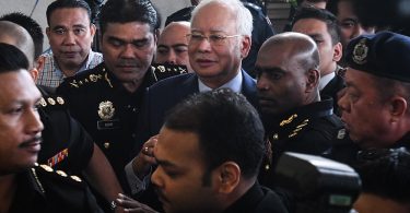 Ex-PM Najib taken to court to face charges