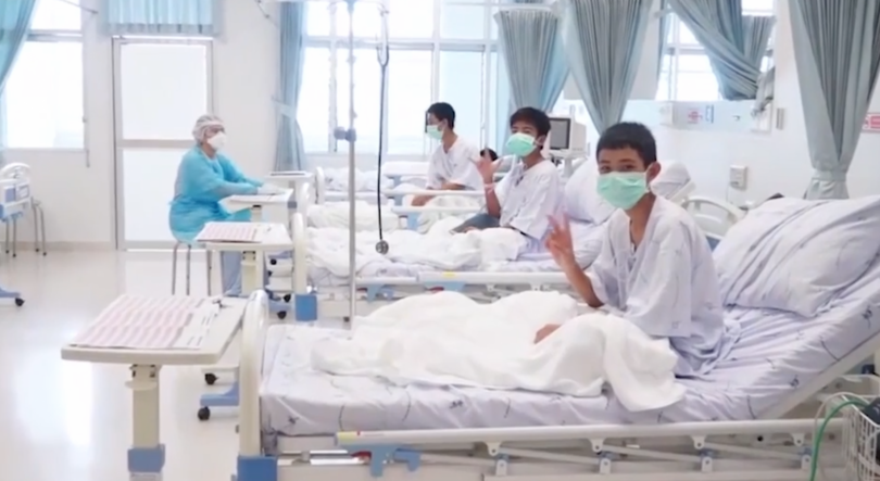 Thai cave rescue: Boys make victory signs from quarantined hospital ward in first video since rescue