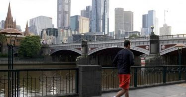 Australia’s COVID-19 hotspot sees more school cases before easing curbs