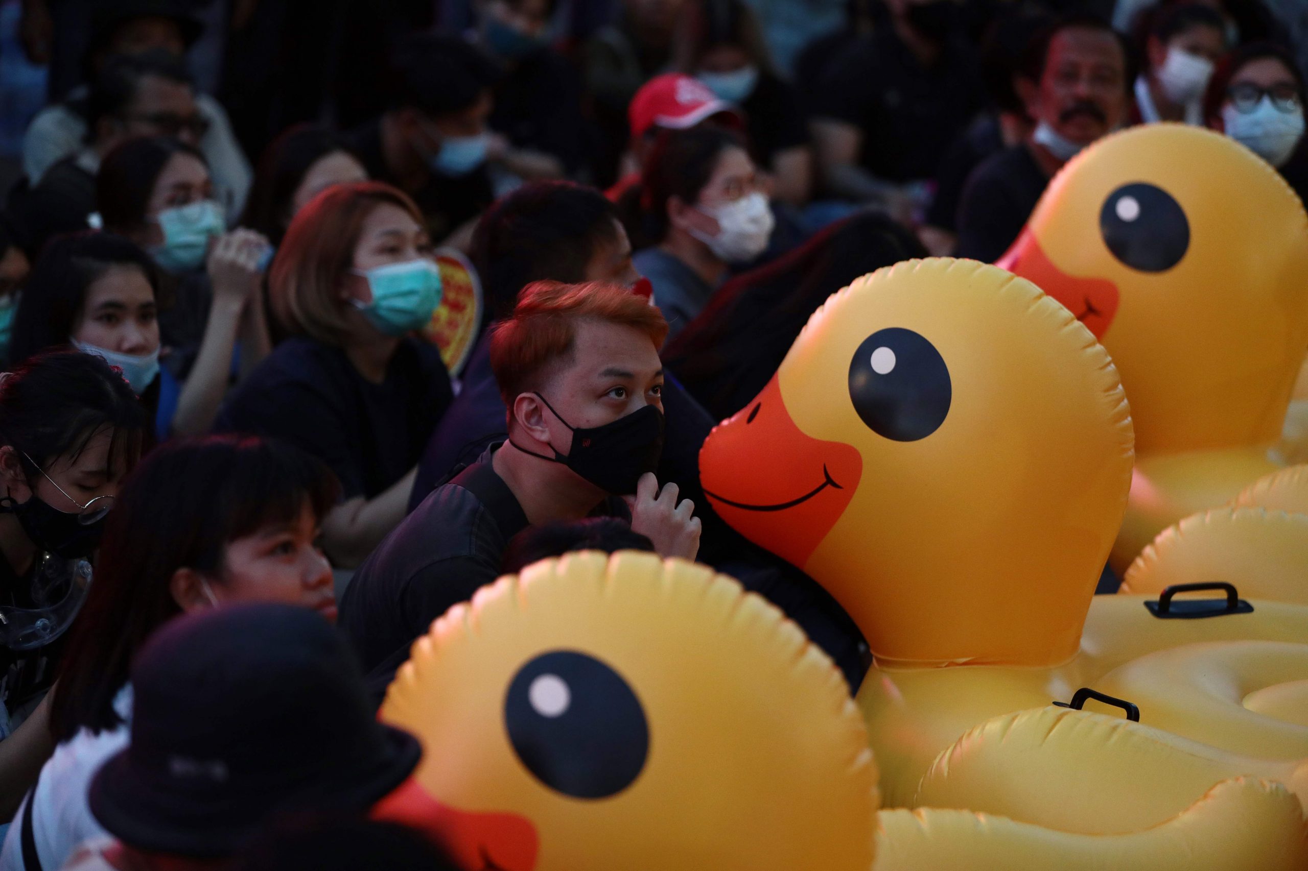 Thai protesters shield themselves from water cannons with giant inflatable ducks