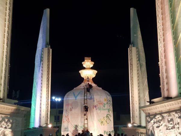 Protesters wrap Democracy Monument with cloth banner