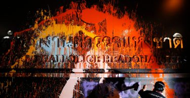 Thailand protesters cover police headquarters with paint after dozens injured in clashes