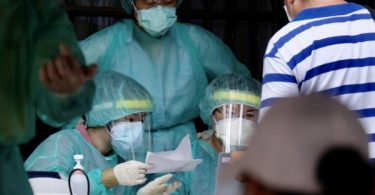 Taiwan raises coronavirus alert level after spike in infections